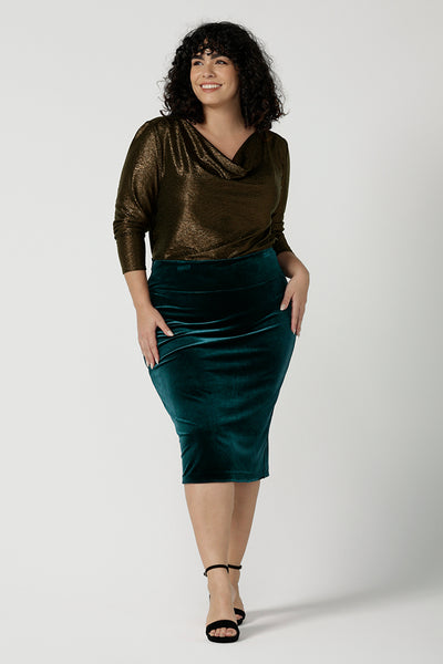 A size 18 woman wears a velour tube skirt in Ivy green with a matching Romy waterfall jacket. Tube skirt in shimmering Velour. Styled back with nude heels and an Eddy Cami. Made in Australia for women size 8 - 24.