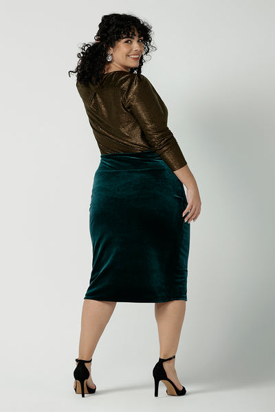A size 18 woman wears a velour tube skirt in Ivy green with a matching Romy waterfall jacket. Tube skirt in shimmering Velour. Styled back with nude heels and an Eddy Cami. Made in Australia for women size 8 - 24.
