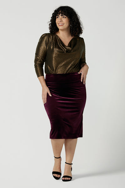 A size 18 woA size 18 woman wears the Brooke velour skirt in Wine Velour. A fitted tube skirt in velour knee length. Styled back with Chrissy top in Bullion xanadu. Made in Australia for plus to petite women size 8 - 24.  
