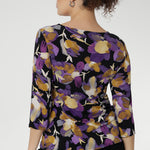 Floral printed top showcases a stunning painterly-style floral print with rich purples and soft yellow hues that bring any outfit to life. Whether you're dressing it up or wearing it under a jacket for a corporate burst of colour. Available in size 8-24.