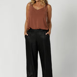 Over 40's model wears black back-to-work pant featuring a perfect blend of comfort and style for the office or any professional setting. Designed in a pull-on, mid-rise style, they offer an easy, seamless fit. The waistband features a bamboo jersey panel at the back, providing extra comfort around the waist and tummy area, ensuring a soft, flexible feel throughout the day.