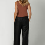 Made from breathable black linen fabric, these pants are lightweight yet durable, offering both style and practicality. With a simple, clean silhouette, they can easily be dressed up or down, making them a versatile addition to any wardrobe. Available in sizes 8-24, these pants offer an inclusive fit that combines ease and sophistication for every body type.