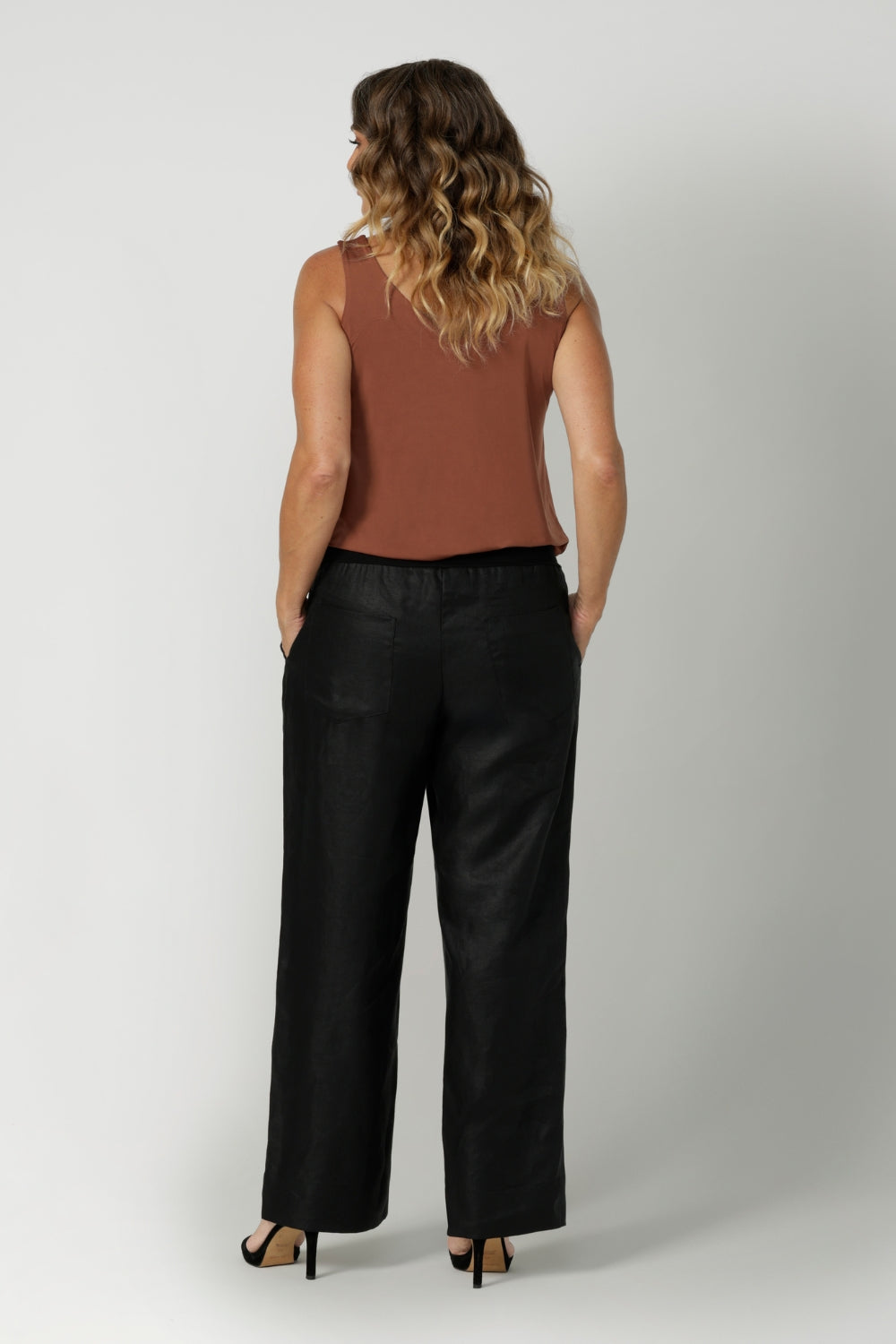 Made from breathable black linen fabric, these pants are lightweight yet durable, offering both style and practicality. With a simple, clean silhouette, they can easily be dressed up or down, making them a versatile addition to any wardrobe. Available in sizes 8-24, these pants offer an inclusive fit that combines ease and sophistication for every body type.