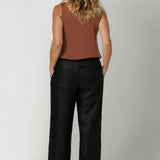 Made from breathable black linen fabric, these pants are lightweight yet durable, offering both style and practicality. With a simple, clean silhouette, they can easily be dressed up or down, making them a versatile addition to any wardrobe. Available in sizes 8-24, these pants offer an inclusive fit that combines ease and sophistication for every body type.