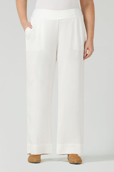 Close up of a curvy size, size 12 woman wearing wide leg pants with pockets. These pull-on, easy care pants are comfortable for your everyday workwear capsule wardrobe. Shop these Australian-made wide leg trousers online in sizes 8 to 24, petite to plus sizes.