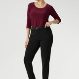 Image of a 40-year-old woman wearing work wear pants in Black Scuba Crepe. This easy care pant is made of scuba crepe fabric and gives a luxe stretch feel. Comfortable off duty pants are made in Australia for women sized 8-24. Pants are photographed with matching black blazer for a full suit look.