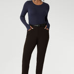 Designed for comfort and versatility, it features a flattering close-to-body fit that moves with you, thanks to its generous stretch and breathable finish. Size 10 woman wears her wool top tucked into her cocoa coloured tapered leg pants. 