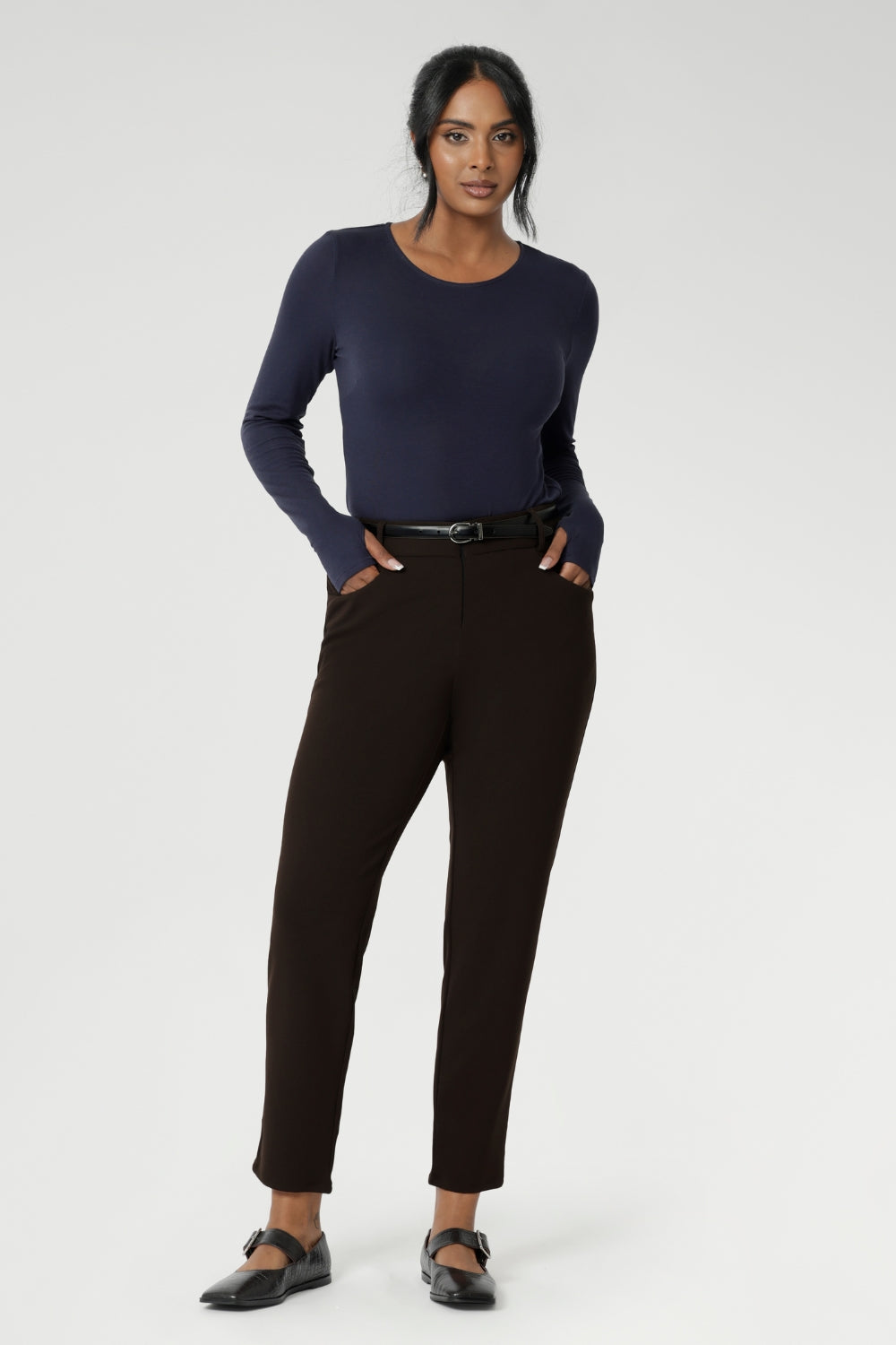 Designed for comfort and versatility, it features a flattering close-to-body fit that moves with you, thanks to its generous stretch and breathable finish. Size 10 woman wears her wool top tucked into her cocoa coloured tapered leg pants. 