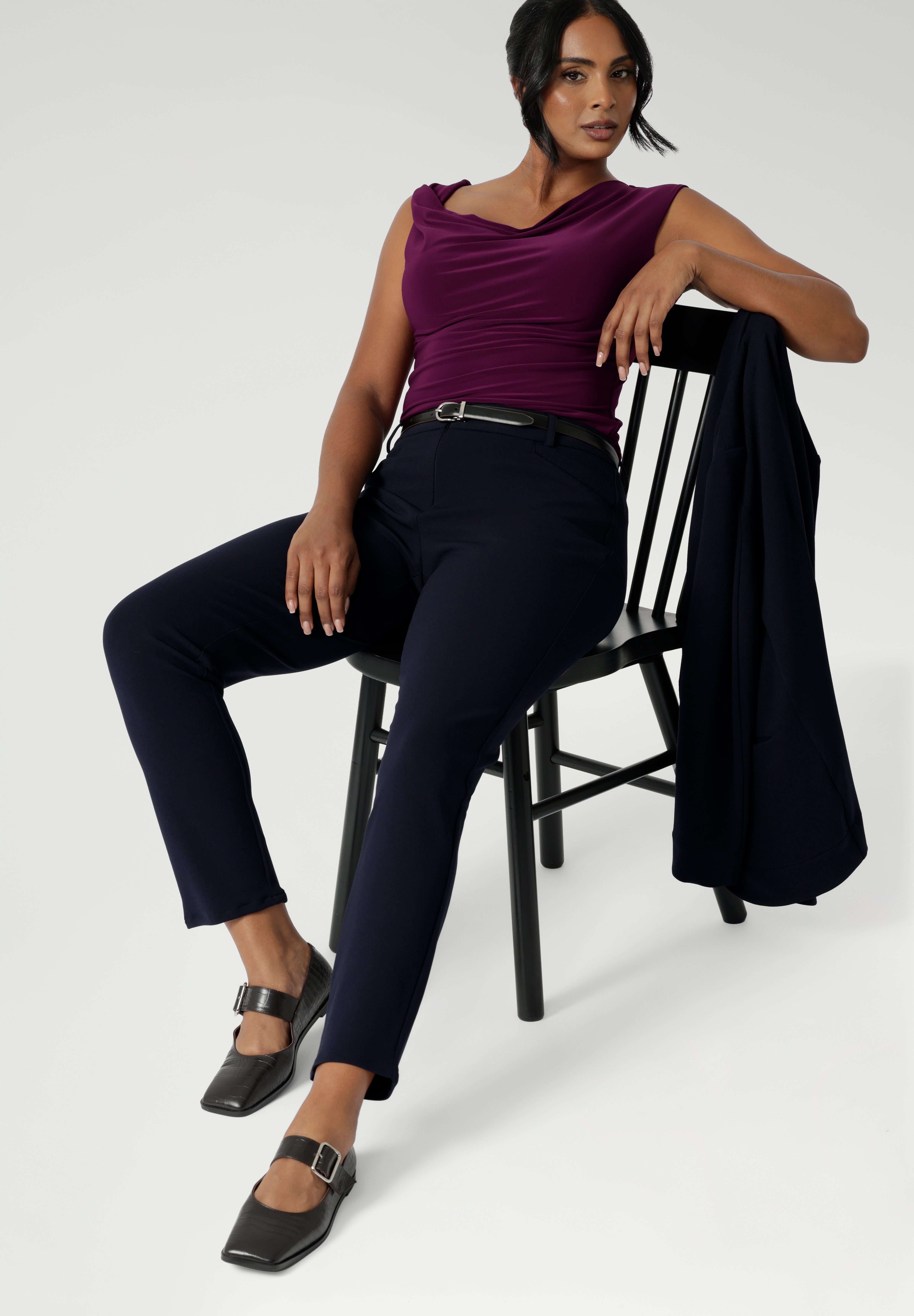 The pants are designed with angled front pockets, giving them a modern touch, while the back darts ensure a tailored fit that contours to the shape of the body. Size 12 woman wears her Corbin Pants with summer cami, heels and matching easy care jacket.