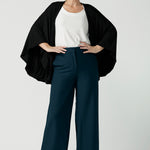 Model is wearing In thermo-regulating, luxurious bamboo jersey Poncho in Black Bamboo by Australian Made brand Leina&Fleur specialising ladies wear in sizes from 8 to 24