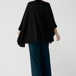 Model is waring In thermo-regulating, luxurious bamboo jersey Poncho in Black Bamboo by Australian Made brand Leina&Fleur specialising ladies wear in sizes from 8 to 24