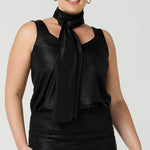 A shimmering jersey neck tie in black puts the finishing touch to a long sleeve, sparkly jersey top for an evening event look. Made in Australia by women's clothing and occasionwear brand, L&F.