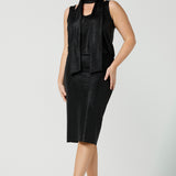 A shimmering jersey neck tie in black puts the finishing touch to a long sleeve, sparkly jersey top for an evening event look. Made in Australia by women's clothing and occasionwear brand, L&F.