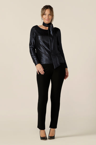 A shimmering jersey neck tie in midnight blue puts the finishing touch to a long sleeve, sparkly jersey top and slim leg, black evening trousers for an alternative event outfit. Made in Australia by women's clothing and occasionwear brand, L&F.