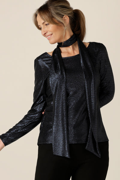 A shimmering jersey neck tie in midnight blue puts the finishing touch to a long sleeve, sparkly jersey top for an evening event look. Australian-made by women's clothing and occasionwear company, L&F.