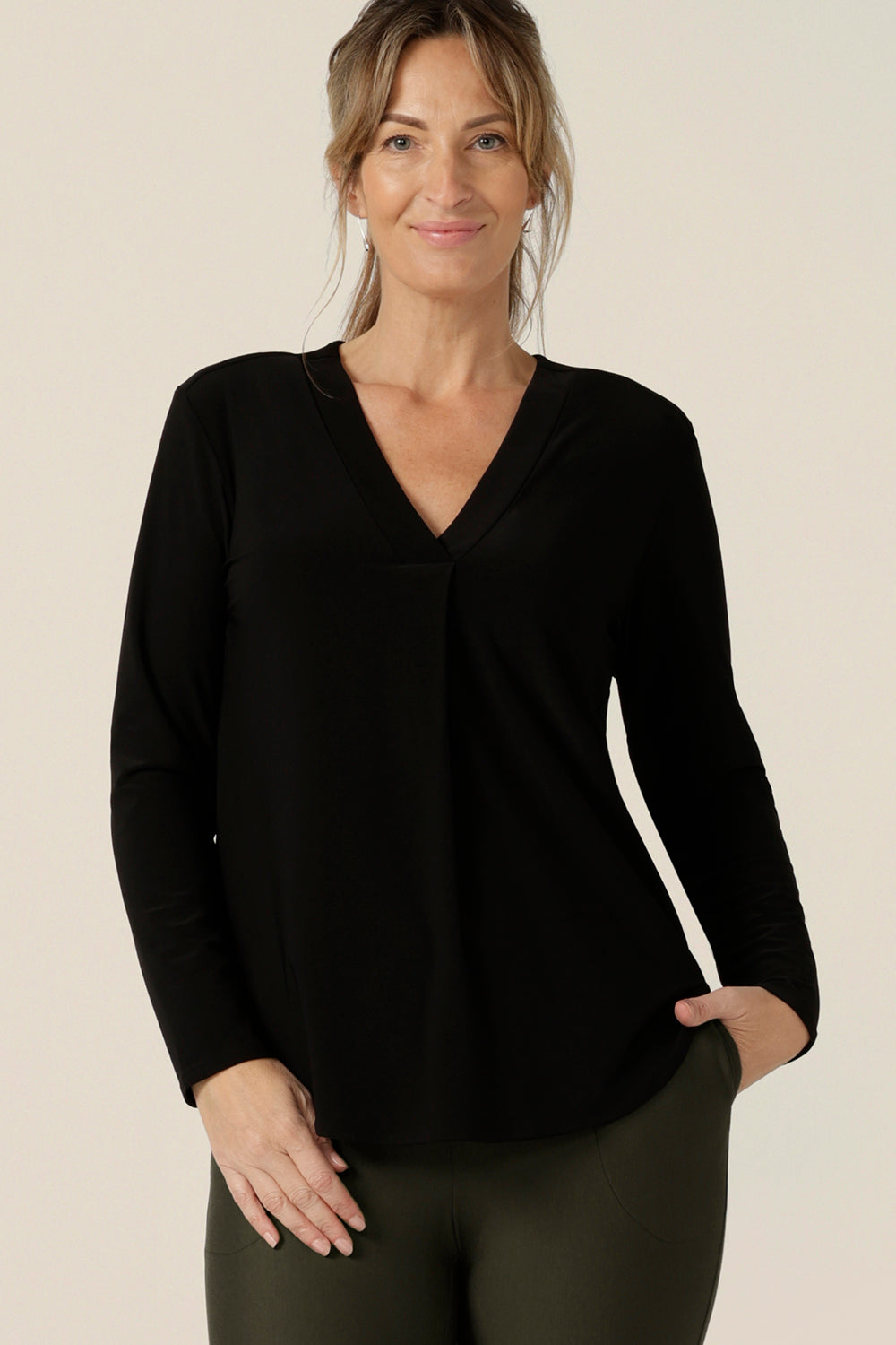 A size 10, 40 plus woman wears a long sleeve top with V-neck in black jersey. Made in Australia by Australian and New Zealand women's clothing label, L&F .