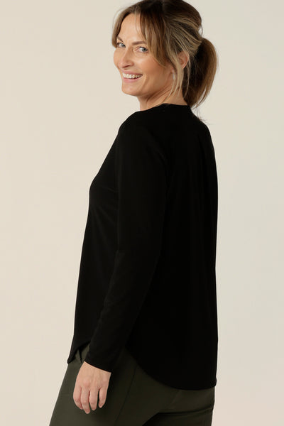 Back view of a  size 10 woman wearing a long sleeve top with V-neck in black jersey. Made in Australia by Australian and New Zealand women's clothing brand, L&F.