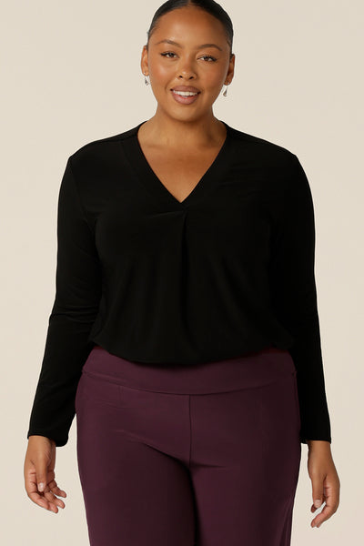 A plus size, size 18 woman wears a long sleeve top with V-neck in black jersey. Made in Australia by Australian and New Zealand women's clothing label, L&F .