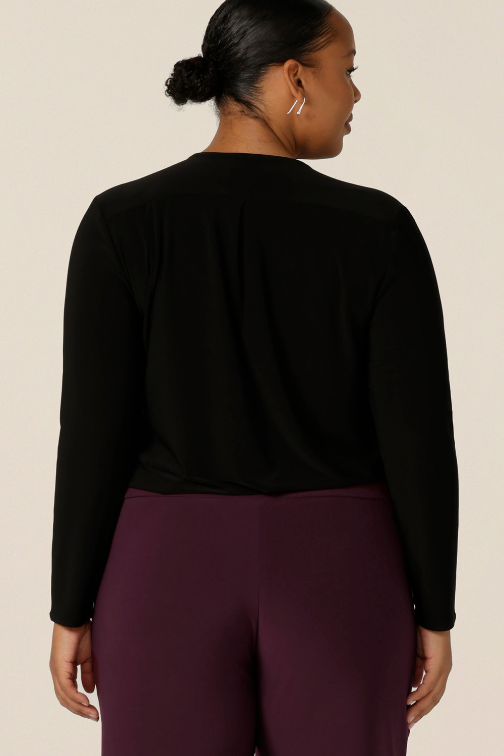Back view of a plus size, size 18 woman wears a long sleeve top with V-neck in black jersey. Made in Australia by Australian and New Zealand women's clothing label, L&F.