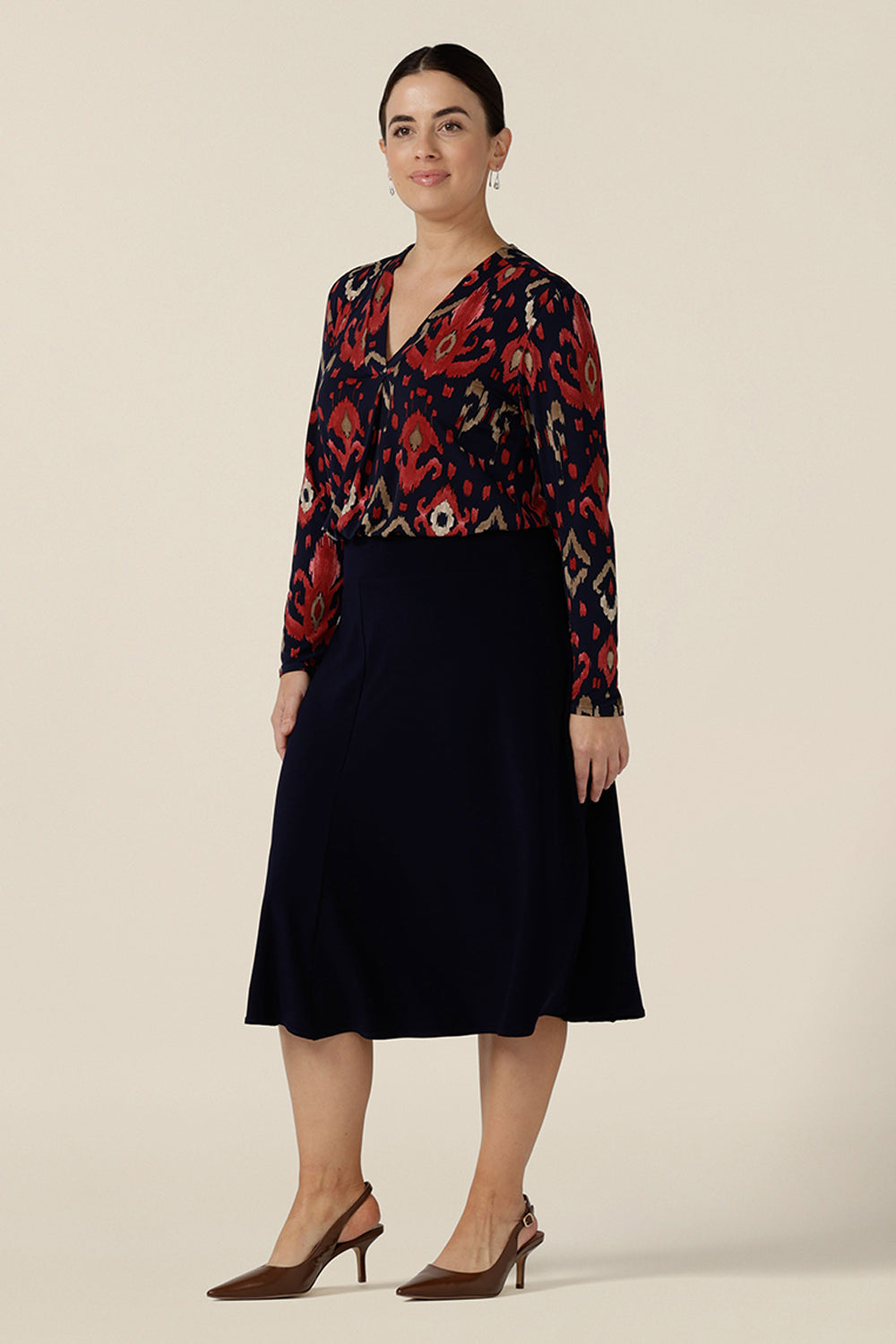A great workwear top for women, the Dakota Top in Ikat is a V-neck, long sleeve top in soft stretch jersey. Worn with a navy blue, knee length skirt, easy care top is styled for corporate and office wear. Made in Australia in sizes 8 to 24, petite to plus sizes.