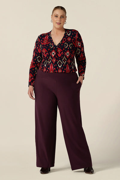 A great workwear top for women, the Dakota Top in Ikat is a V-neck, long sleeve top in soft stretch jersey. Worn with wide leg pull on trousers as an elegant work outfit. Shown here in a size 18 on a curvy woman, this top is made in Australia in sizes 8 to 24, petite to plus sizes.