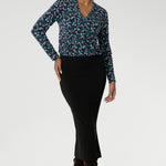 In the vibrant Peacock print, this range comes alive with rich, eye-catching hues of blue, mint, and berry—bringing energy and warmth to grey winter days. The jersey shirt features a flattering V-neckline with a soft front tuck that adds structure without stiffness, full-length sleeves for added coverage, and a gently curved shirttail hem that creates a clean finish whether worn tucked or loose.