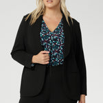 Jersey shirt features a flattering V-neckline with a soft front tuck that adds structure without stiffness, full-length sleeves for added coverage, and a gently curved shirttail hem that creates a clean finish whether worn tucked or loose. A shoulder yoke and centre-back tuck lend subtle tailoring to the relaxed silhouette, making it easy to dress up or down.