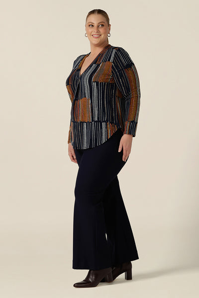 A casual top for plus size women, this V-neck top with long sleeves is worn with wide leg navy blue pants. In a fine knit jersey fabric, this non-iron top is made in Australia by women's clothes brand, Leina & Fleur. Shop tops online in sizes 8 to 24. 