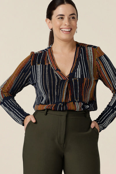 A casual top for women, this V-neck top with long sleeves and shirttail hem is shown in size 10. In a fine knit jersey fabric, this non-iron top is made in Australia by women's clothes brand, Leina & Fleur. Shop tops online in sizes 8 to 24.