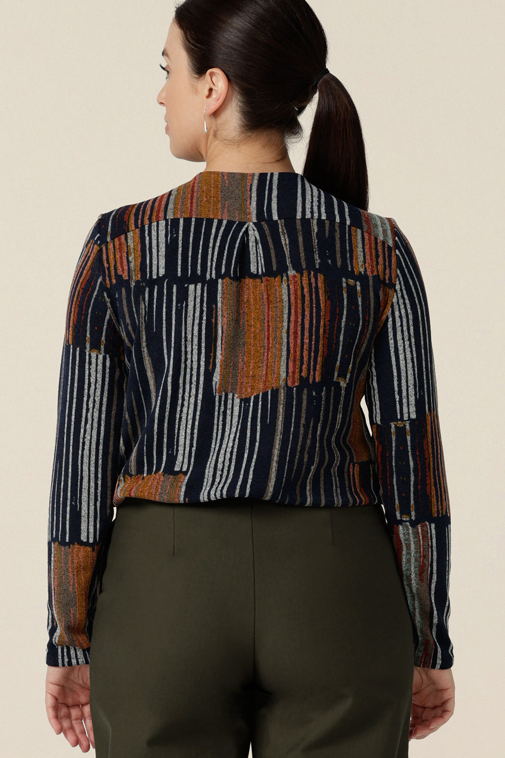 Back view of a casual top for women - this V-neck top has long sleeves and shirttail hem. In a fine knit jersey fabric, this non-iron top is made in Australia by women's clothes brand, Leina & Fleur. Shop tops online in sizes 8 to 24.