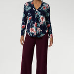 A classic V-neckline is complemented by a tailored front tuck, creating a flattering silhouette that enhances your shape. Thoughtful design details such as a shoulder yoke with a center-back tuck and full-length sleeves provide structure and style. The curved shirt-tail hemline offers a gentle, flowing finish, making this floral top ideal for wearing loose or tucked in. Whether you’re dressing for work, a casual day out, or layering up for the season, the Dakota Top is a must-have addition to your wardrobe.