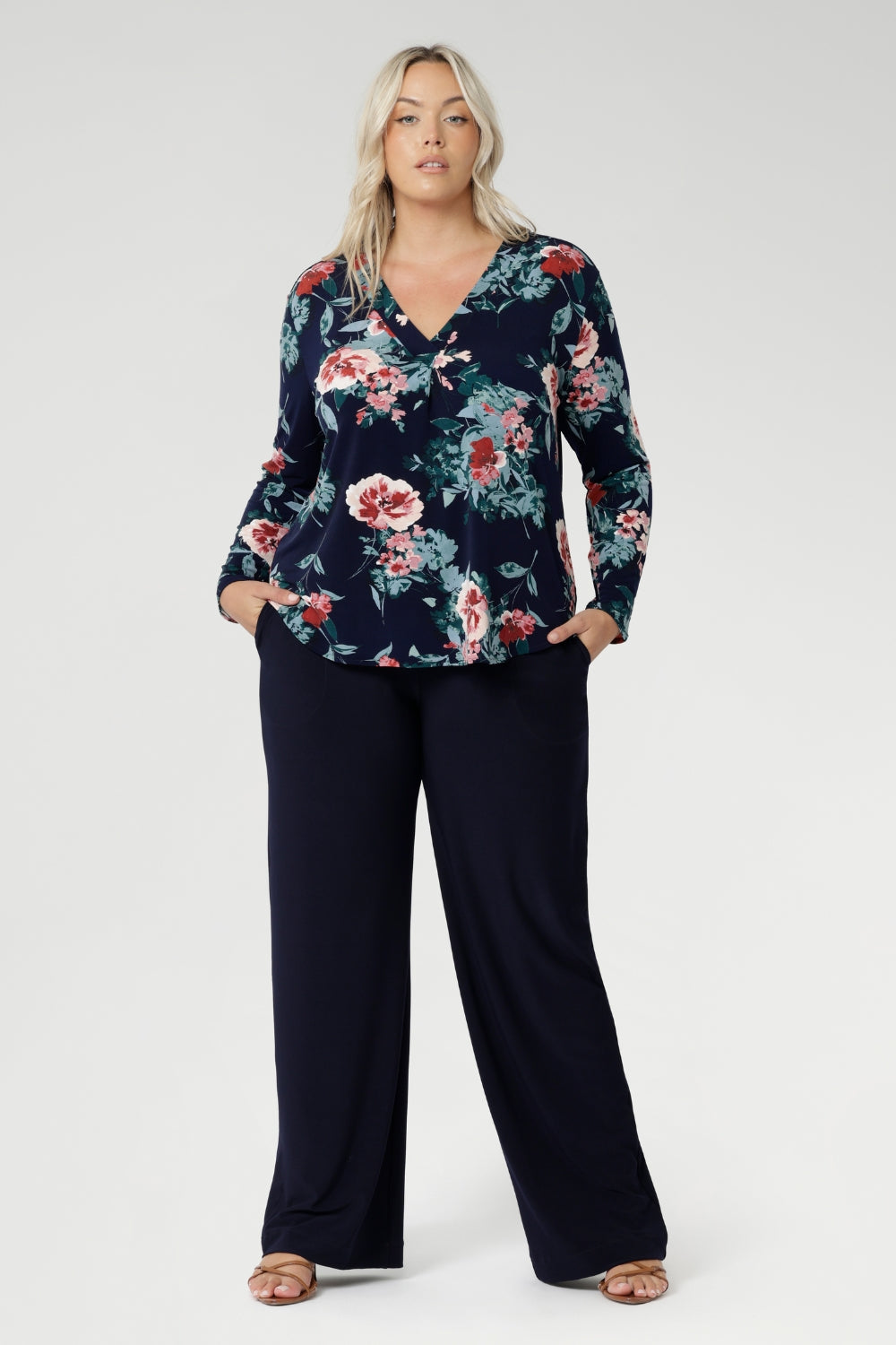 A classic V-neckline is complemented by a tailored front tuck, creating a flattering silhouette that enhances your shape. Thoughtful design details such as a shoulder yoke with a center-back tuck and full-length sleeves provide structure and style. 