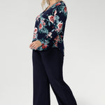 The floral pattern, highlighted in soft shades of pink, red, and blue, adds a timeless feminine touch while the stretch-infused fabric ensures all-day comfort and ease of movement.

A classic V-neckline is complemented by a tailored front tuck, creating a flattering silhouette that enhances your shape. Thoughtful design details such as a shoulder yoke with a center-back tuck and full-length sleeves provide structure and style. 