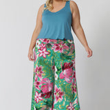 Plus sized woman wears pull-on style culottes made of slinky jersey fabric that provides a soft, fluid drape that moves with you. Wrinkle-resistant, these culottes stay fresh and smooth all day, making them ideal for travel or busy days filled with events. With their vibrant floral print and effortless design, these culottes are a must-have for a chic, resort-ready look. Dany Culotte in Malibu are stocked in size 8-24.