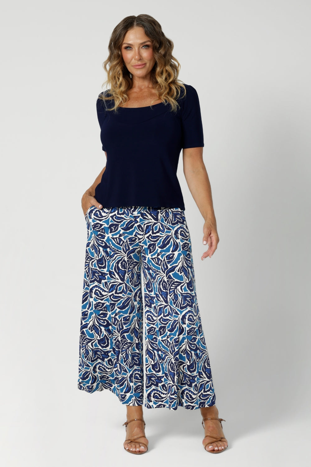 These Leina & Fleur Dany Pants are a highly sought-after style that combines comfort, versatility, and a flattering fit for all heights. Part of the Blue Hana print collection, these pants are crafted from a slinky jersey fabric that offers a soft, full-body stretch, providing a smooth, flattering silhouette and all-day comfort. Available in size 8-24.