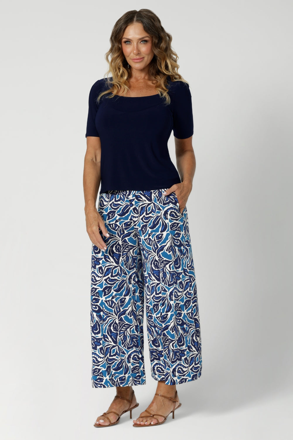 The pull-on style pants feature a double-layer waistband that ensures a secure fit while maintaining a sleek, streamlined look. Size 12 woman wears extra-wide culotte pants, that offer an effortlessly chic shape, providing both movement and style with every step. 