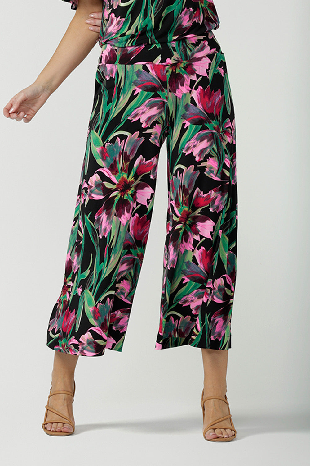 Crop in of a size 10, 40 plus woman wearing printed jersey, wide leg pants with matching floral print jersey top, for spring/summer 23. Pull-on pants with a deep waistband, the cropped, culotte legs make great summer pants that work for petite heights as well as taller women. Shop pants online in sizes 8 to 24.