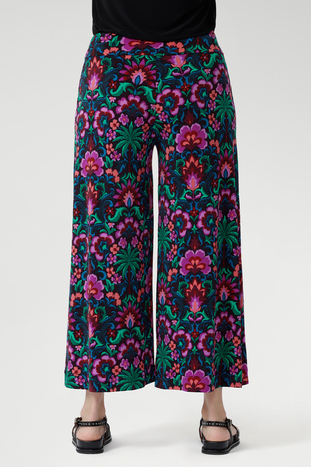 Featuring a bold floral print in vibrant shades of pink, green, burgundy, and blue, these culottes are designed with a modern, extra-wide leg that delivers both style and ease. The pull-on style with a double-layer waistband ensures a smooth, flattering fit, while functional side pockets with visible stitching add a touch of detail and practicality.