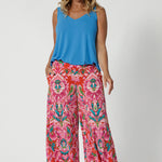Bamboo summer cami is a perfect blend of elegance and functionality, crafted from luxurious, high-quality bamboo fabric in a serene opal colour. Its sleek, sleeveless design makes it an ideal choice for warm weather, offering a breezy and flattering fit. Model pairs bright cami with printed pants for a summer ready outfit. 