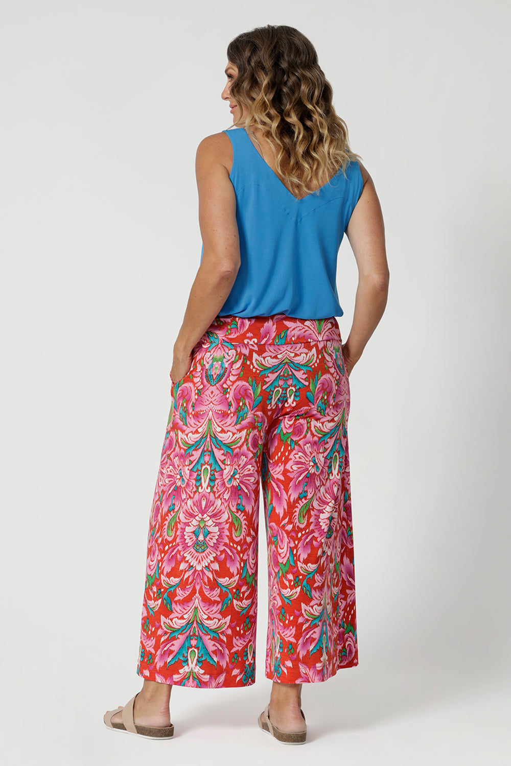 Size 12 woman wears printed culotte. Perfect fusion of style and comfort, featuring an eye-catching abstract summer design that adds a playful yet sophisticated touch to your wardrobe. Made from lightweight crepe jersey fabric, they offer a soft, stretchy feel that is cooling and comfortable against the skin. Summer ready culottes are available in sizes 8-24. 