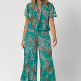 Part of Leina & Fleur's jade safari range, over 40's woman wears jade coloured ensemble with animal print details in a cropped culotte pant and matching printed top - creating faux jumpsuit look. Available in size 8-24.