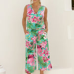 40 year old woman wears Joni top in Malibu matched with printed Dany Culotte in Malibu, creating a faux jumpsuit styled look. The matching set provide a polished yet effortless look ready for the summer event season. Made of easy care slinky fabric, these garments are an amazing travel essential with their wrinkle resistant qualities. Stocked in sizes 8-24, there is a size for everyone at Leina & Fleur.