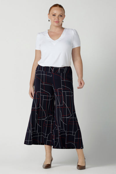 Size 12 woman wears the Dany Culotte in Navy Abstract. Corporate comfortable pant for women, geometric print with navy, red and white. Made in Australia for women size 8 - 24. 