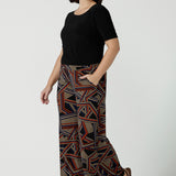 A size 10 woman wears the Dany Culotte in Trixie, a printed Jersey work pant with a geometric pattern. Wide leg with functional pockets and wide waistband. Cropped length and petite height friendly. Made in Australia for women size 8 - 24.