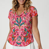 This summer-ready top is the perfect blend of style and comfort, designed with a tropical abstract print that evokes the laid-back vibe of resort living or vacation getaways. Crafted from lightweight crepe jersey, the fabric is breathable, soft, and offers just the right amount of stretch for a flattering, flexible fit. The top features a short-sleeved design and a sophisticated cowl neckline, adding elegance to your casual look. Proudly Australian-made & ideal for warm-weather. Sizes 8-24 available. 