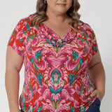 Cowl neck blouse worn by plus sized model is crafted from lightweight crepe jersey, the fabric is breathable, soft, and offers just the right amount of stretch for a flattering, flexible fit. Leina & Fluer an Australian manufactured fashion label proudly stocks sizes 8-24 in this summer ready top. 