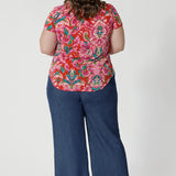 The fabric used for summer ready top has stretch, providing a flattering, flexible fit that moves with you. Its effortless design and relaxed silhouette make it a versatile addition to your summer wardrobe, ideal for both daytime adventures and evening strolls by the shore. Size 18 model showcases her Daryl top with her jeans and a brown heel for an elevated day look. 