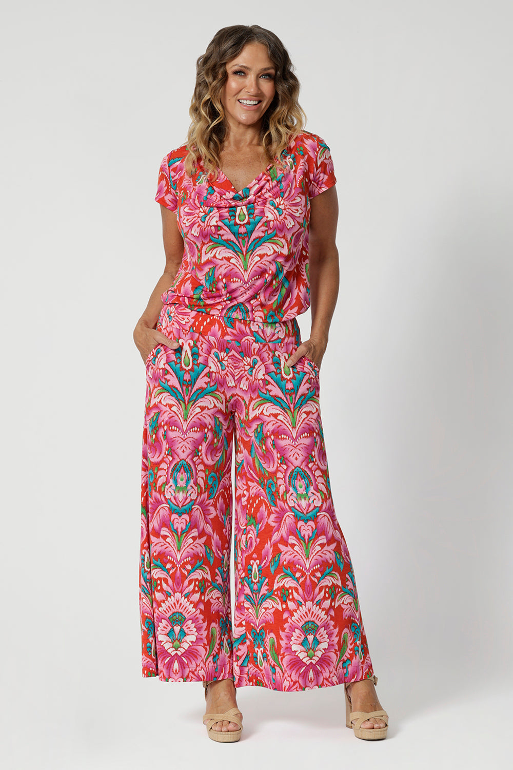 Australian made printed wide leg pants are seen on sizes 12 woman worn with printed blouse to match. Displaying a chic style choice of a faux jumpsuit, which compliments any wardrobe. Both summer printed pieces are available at Leina & Fleur in sizes 8-24. 