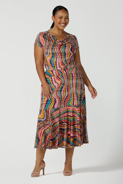 Curvy size 16 woman wears the Daryl Top in Kaleidoscope. A cowl neck style top with rainbow stripes and slinky.  Soft Slinky jersey made in Australia for women in size 8 - 24.