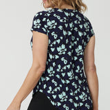 Back view of a good summer top for women. Show on a size 12, over 40s woman , this is the back of a cowl neck top in aqua blue floral print. A short sleeve top for summer, this comfortable top is made from stretch jersey and is an easy-care top style. Made in Australia by Australian and New Zealand women's clothes brand, Leina & Fleur.